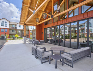 Outdoor lounge area between the clubhouse and fenced-in pool at The Lodge Apartments at Marysville, WA.