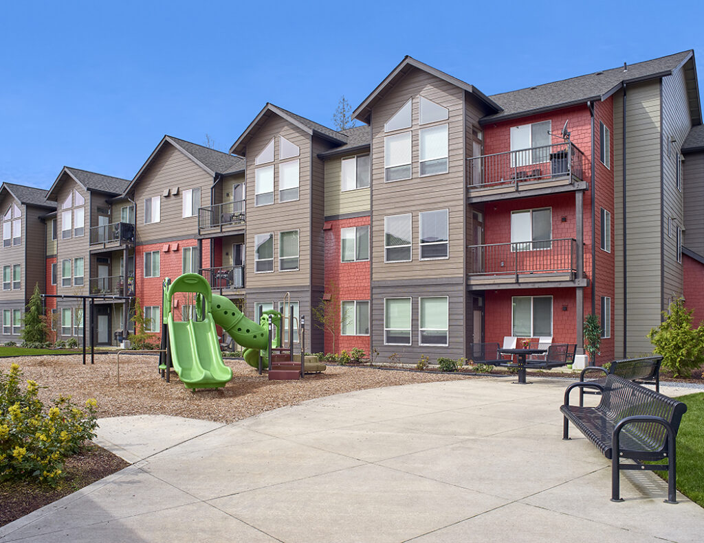 Exterior of The Lodge Apartments with a playground at Marysville, WA.