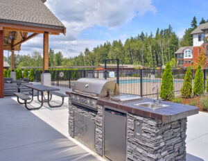 Grilling area in front of the fenced-in pool area at The Lodge Apartments at Marysville, WA.