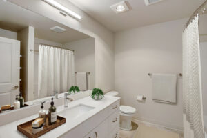 Bathroom with large mirror and bathtub at The Lodge at Marysville, WA.