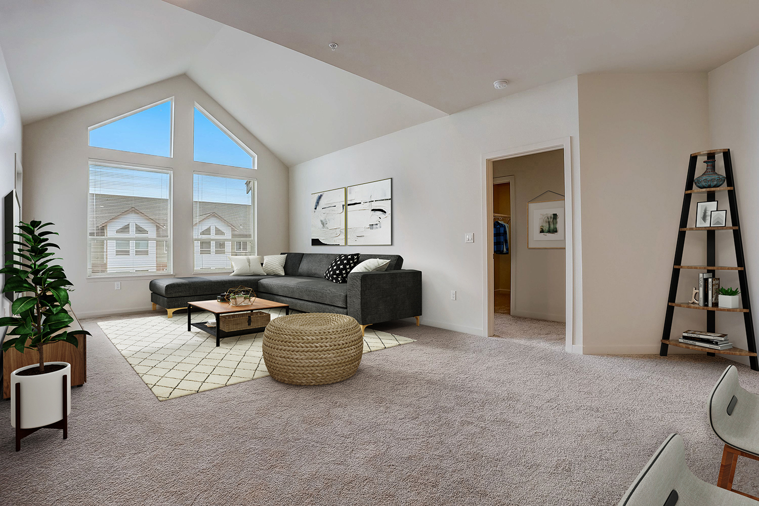 Large living room with floor-to-ceiling window at The Lodge Apartments.