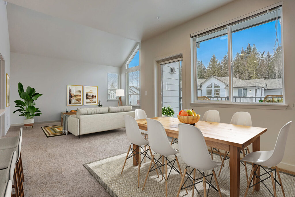 The interior dining and living room with a large window at The Lodge Apartments.