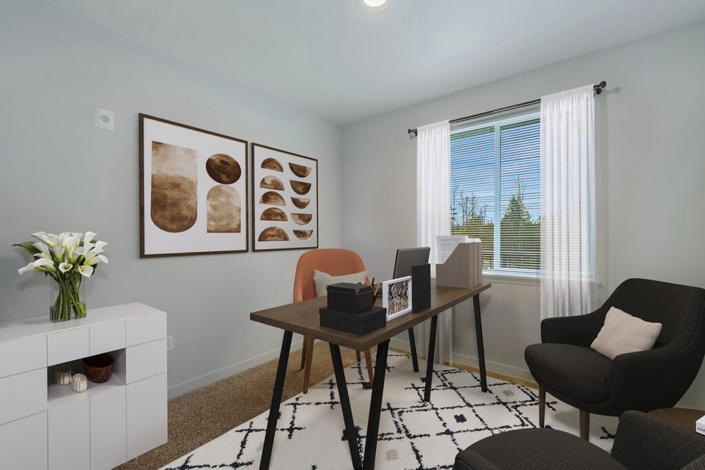 A second bedroom with a window and carpet flooring, which can be used as an office space.